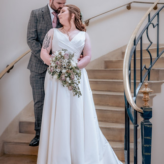 bride and groom photo of them on the stairs at Bury St Edmunds Registry Office