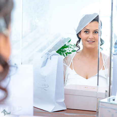 Reflection of bride getting ready