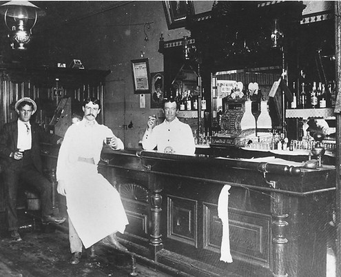 Black and white photo of an old saloon.