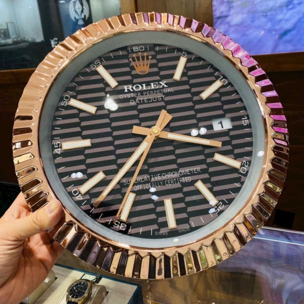 Modern luxury wall clock with deep blue wave pattern dial, rose gold fluted bezel and luminous hour markers