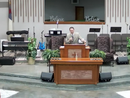 Pastor Chris Buscher preaching from Hebrews 11:5–6 about Enoch, faith, and walking closely with God.