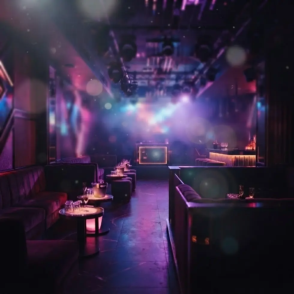 Studio photography of a dimly lit, upscale nightclub interior with velvet lounge seating. Vibrant purple and blue mood lighting creates an energetic and mysterious atmosphere.