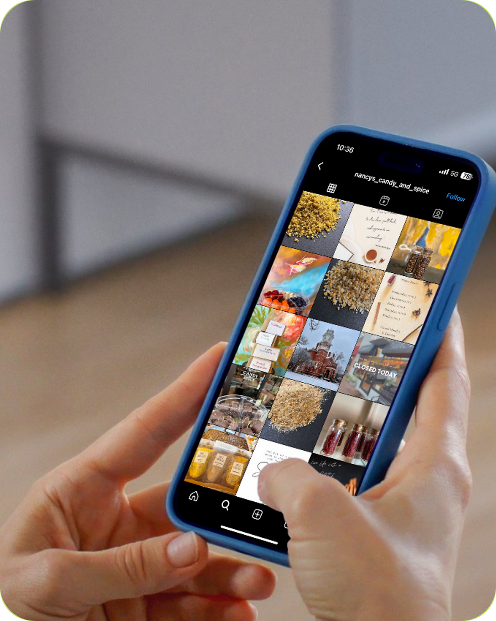 A female holding a phone showing an instagram feed