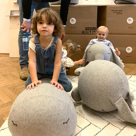 girl rocking on play furniture rocking whale on fair booth