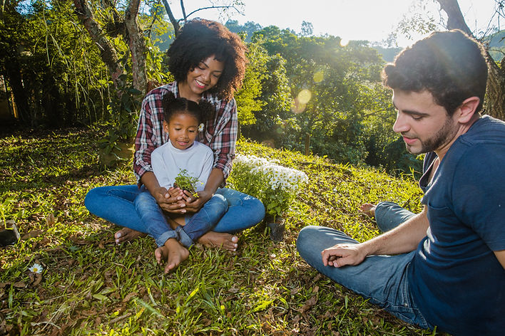 parents-with-daughter-sitting-hill.jpg