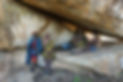 Four elders sitting under rock shelter