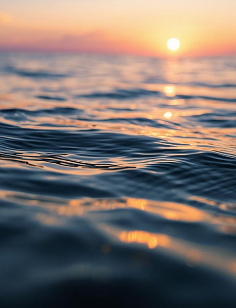 Create an image of ripples in the water, with a sunset in the distance of the background w