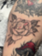 Small bunny sleeping inside a peony tattoo