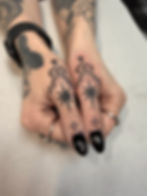handpoke Symmetrical star and ornamental tattoos on thumbs.