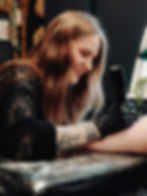 Lydia, female tattoo artist in Milton Keynes working on a client.