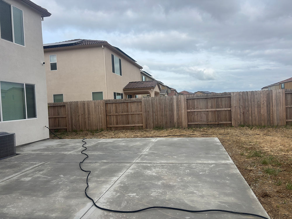 Backyard with concrete patio, fence, ideal for Yuba City landscaping