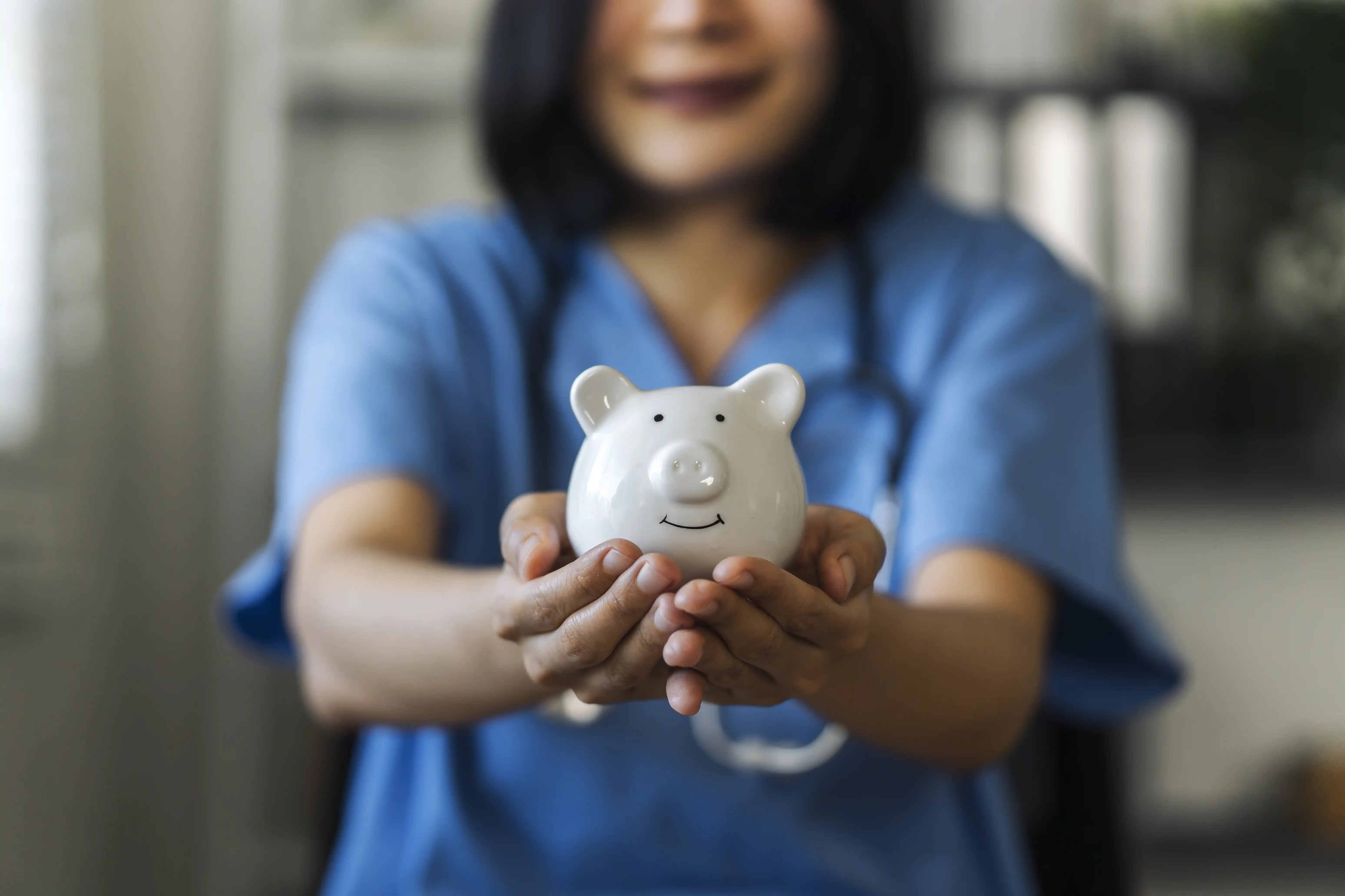 nurse-or-doctor-with-stethoscope-holding-piggy-ban-2025-03-25-03-20-57-utc_11zon.webp