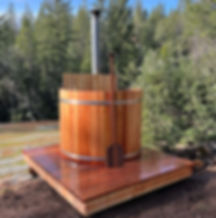 5' diameter wood fired Red Grandis hot tub with paddle on backyard deck