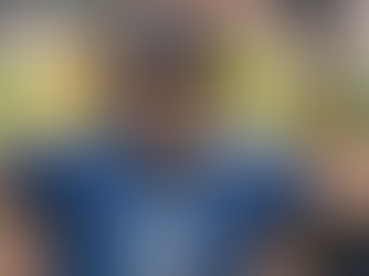 England cricketer Jacob Bethell celebrates passionately with arms outstretched while wearing a helmet and blue England jersey during a match.