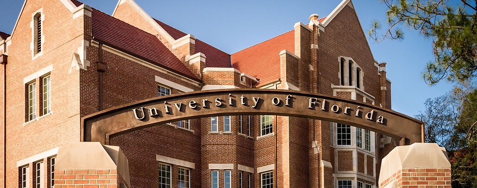 University of Florida campus entrance featuring the iconic “University of Florida” arch and historic red-brick academic buildings