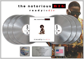 Custom multi-platinum Ready to Die plaque award featuring six silver vinyl records, central album artwork from The Notorious B.I.G.’s Ready to Die, RIAA multi-platinum certification hologram, engraved presentation plate, and USA flag detail in a luxury framed display. Bespoke music industry award created by Plaque Awards Ltd.