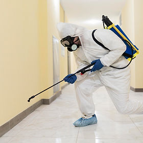 full-shot-man-disinfecting-building.jpg
