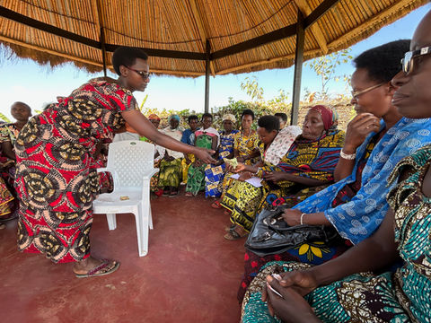 women sit in a circle outside