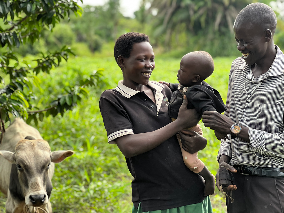 Douglas, Eunice, Innocent, and one of the cows he will use for the dowry.