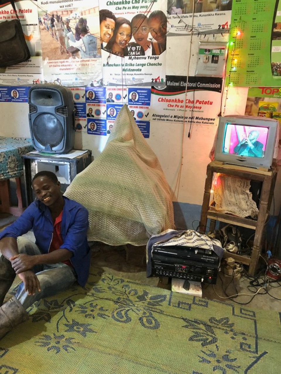 man posing with TV and radio system