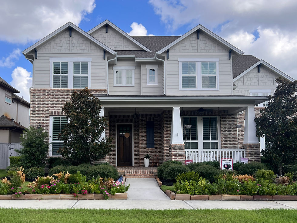 Brick and vinyl sided craftsman style home on Footbridge Way in the Liberty Branch area of Creekside Park in The Woodlands, Texas