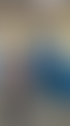 Communities for Youth staff member points at a bar graph poster on the wall, presenting to a group of four people in a hallway with blue lockers.