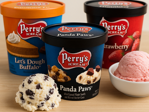Four pints of Perry’s Ice Cream—Panda Paws®, Let’s Dough Buffalo®, and Strawberry—arranged on a light wood surface with scoops of ice cream in front.