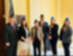 Eye-level view of congressional hearing room with veterans and officials seated