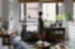 Woman standing in front of a window in a home office setting.