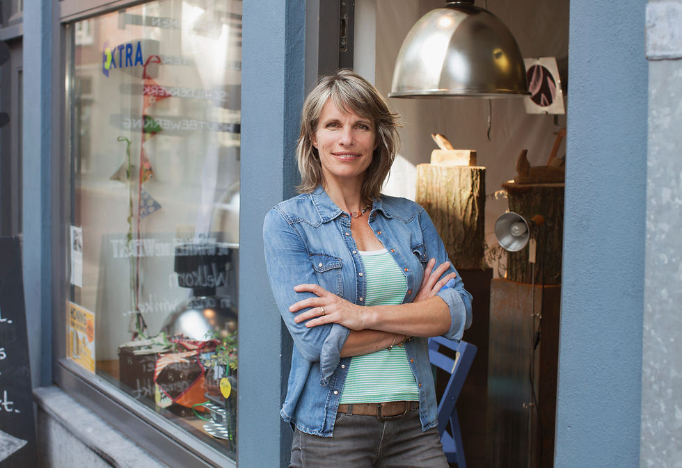 Business owner standing in the door of her store.