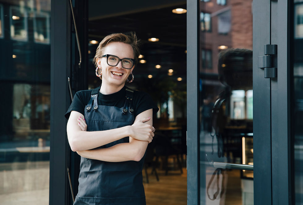 Smiling person standing outside of a store.