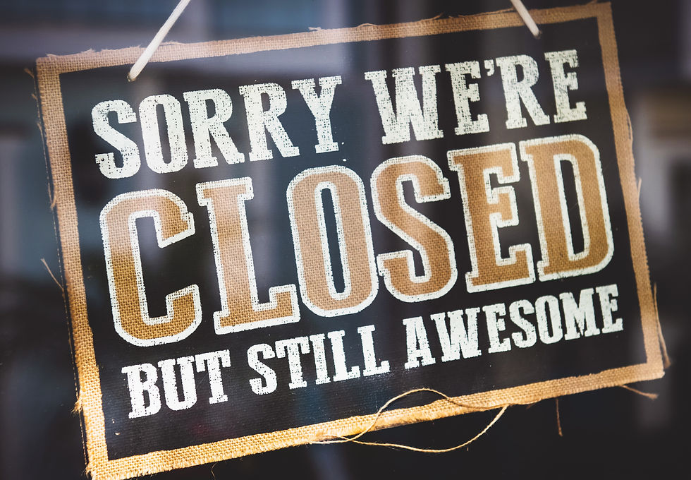 Closed sign hanging in store window