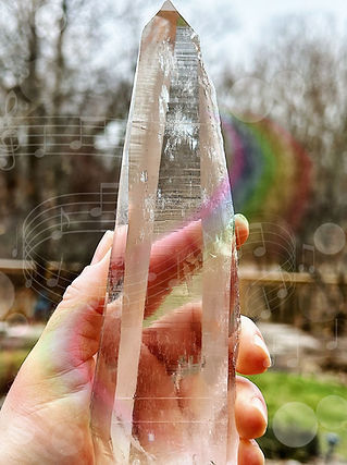 A female holding a large clear quartz lemurian seed point