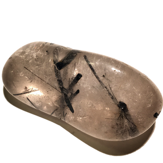 A quartz stone with tourmaline rods within