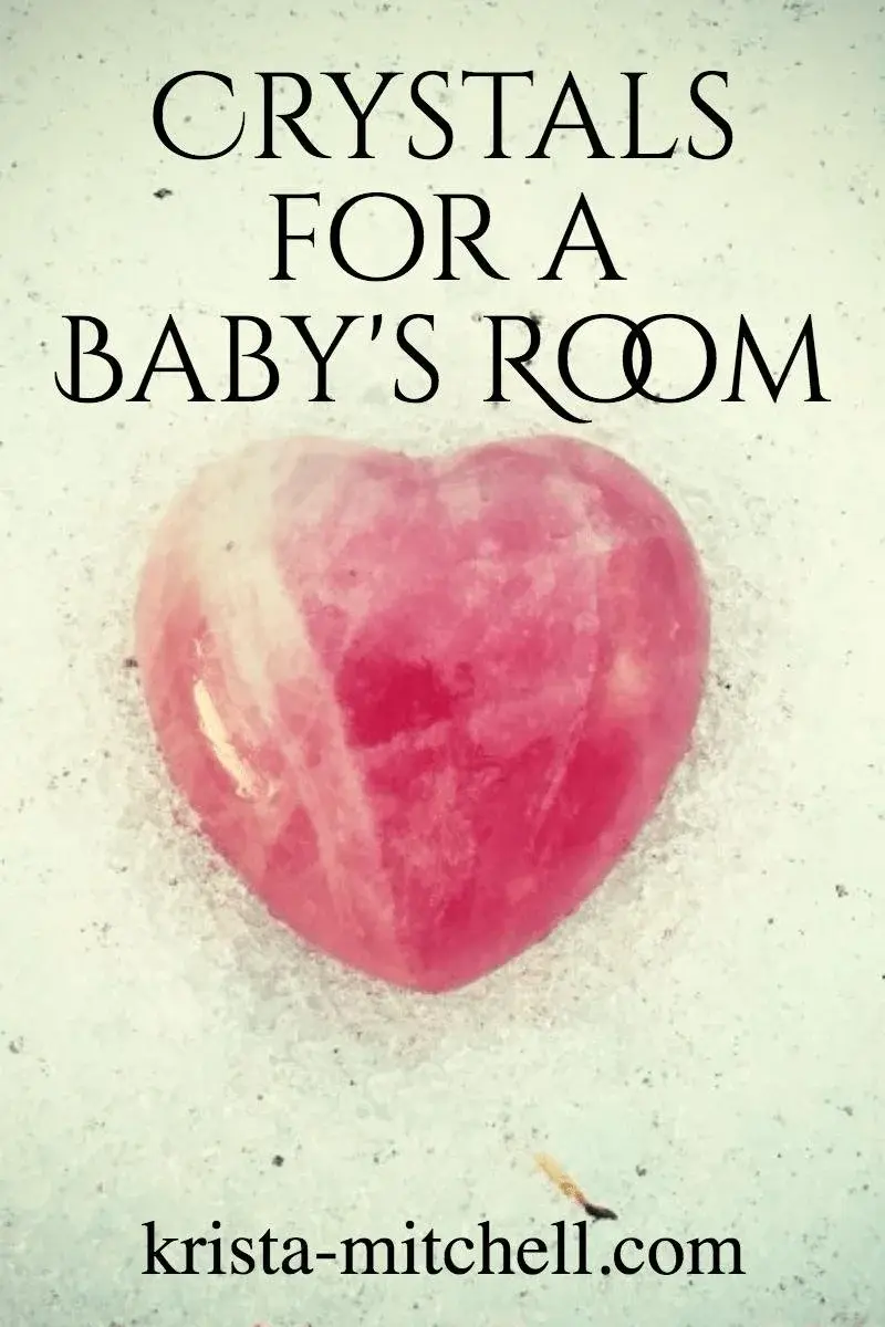 Pink heart-shaped crystal on pale background with text CRYSTALS FOR A BABY'S ROOM and krista-mitchell.com