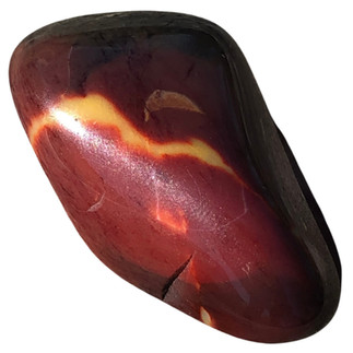 A polished mauve red mookaite jasper stone with red veins