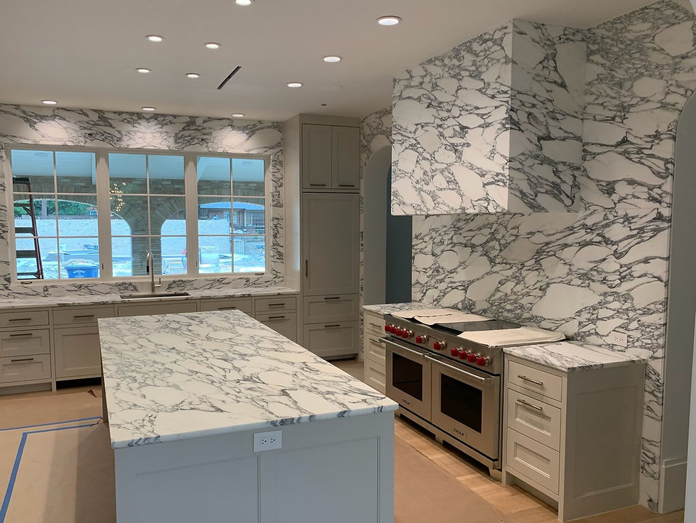 black and white streaky circular pattern wall marble installed in a kitchen with a window