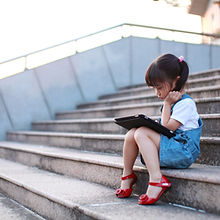 Cute-girl-playing-with-a-tablet-computer