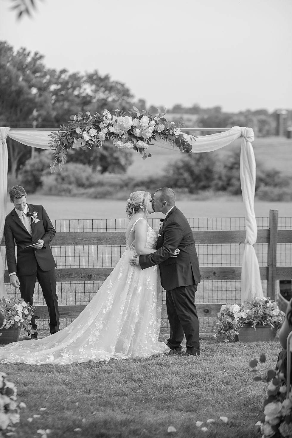 Bride and groom sharing first kiss as newlyweds