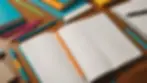 Close-up view of an open notebook with colorful study materials