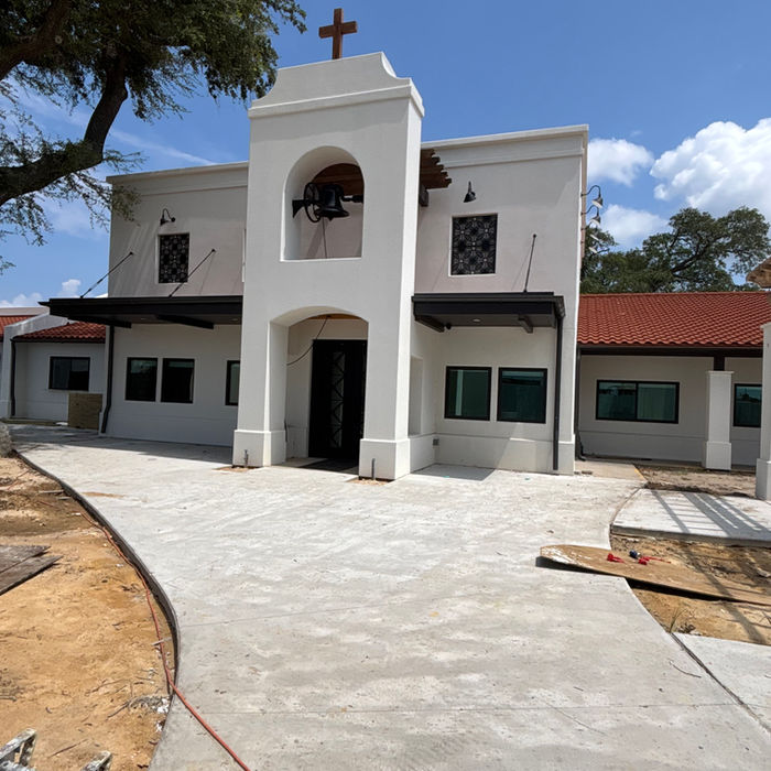 Completed commercial stucco exterior with arched entrance