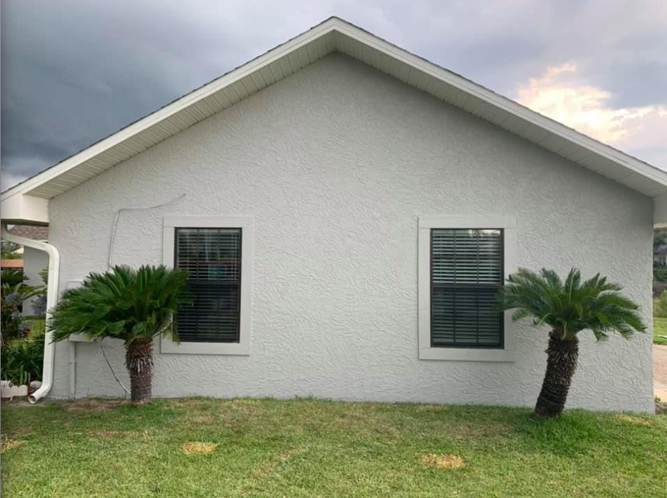 New construction home with finished gray stucco exterior.png