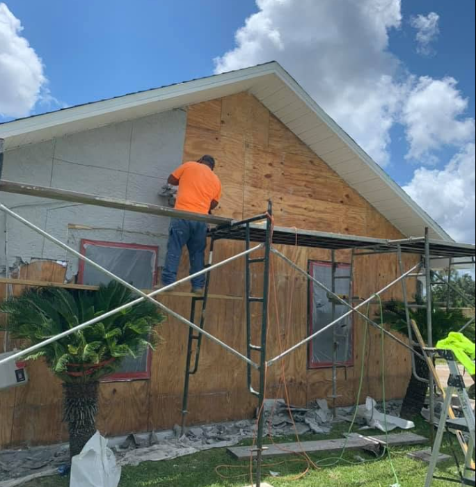 All Pro Stucco crew applying exterior stucco finish to residential home