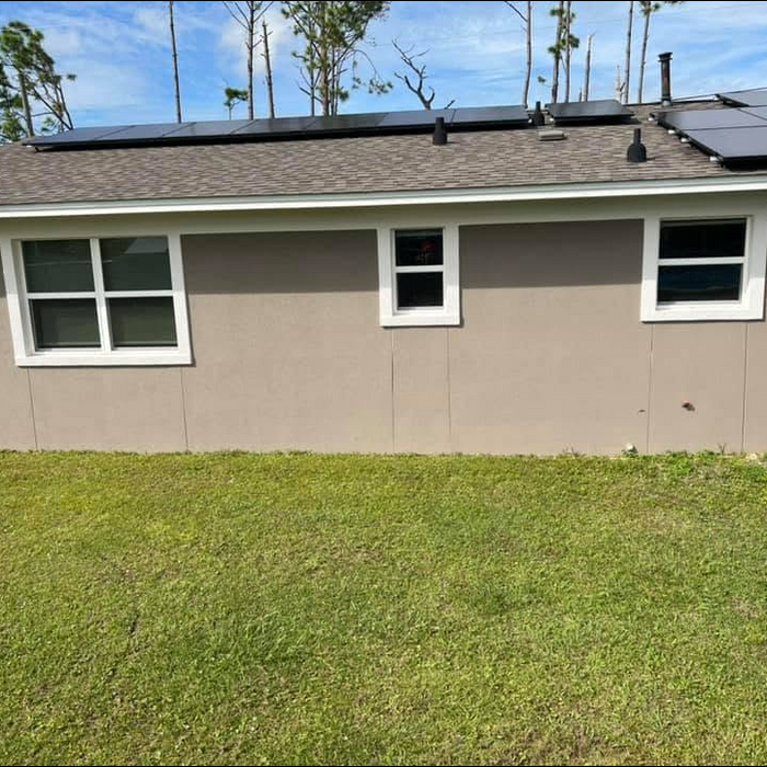 Completed neutral stucco exterior on single-story residential home