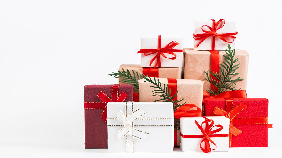Stack of colourful staff gifts with red ribbons and pine sprigs on white background, conveying a festive mood.