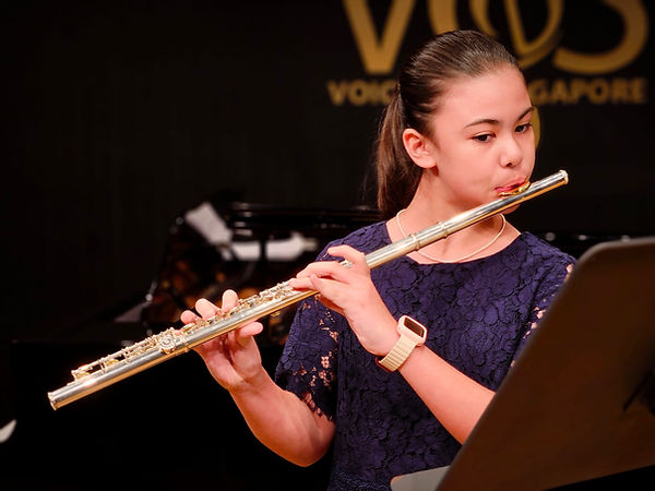FAMA student playing flute at concert