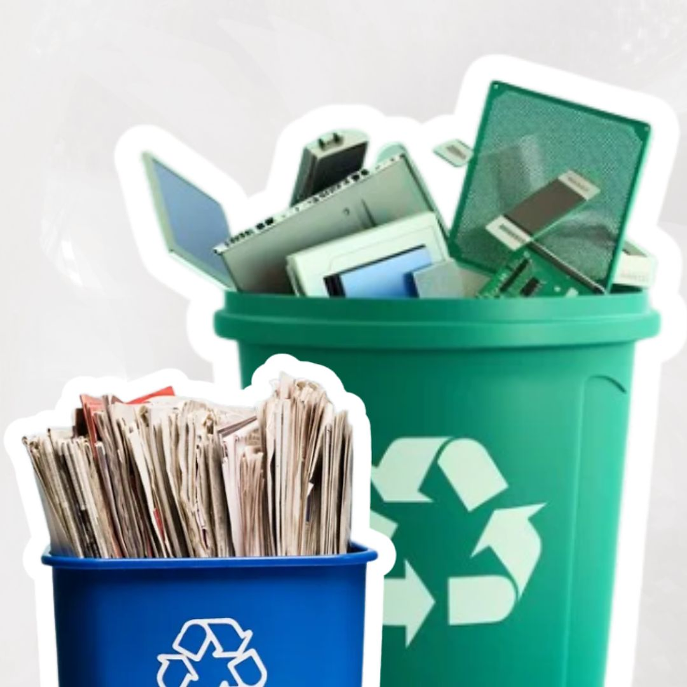 Blue bin with newspapers and green bin with electronics, both with recycling symbols, on a neutral background, emphasizing recycling.