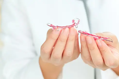 compressed_dentist-holding-retainer-2026-03-20-02-03-33-utc.webp