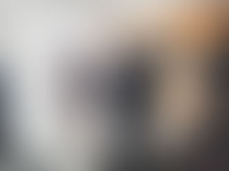 Groom dancing while holding brides hand as they walk down the aisle at the end of their wedding ceremony in the Roald Suite at voco St David's Hotel in Cardiff Bay