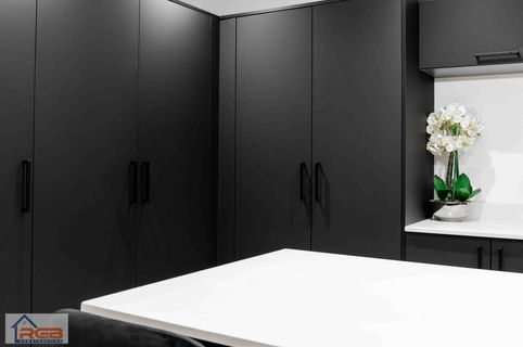 Black matte finish interior kitchen cupboards installed in a rear house extension at a property in Cardiff